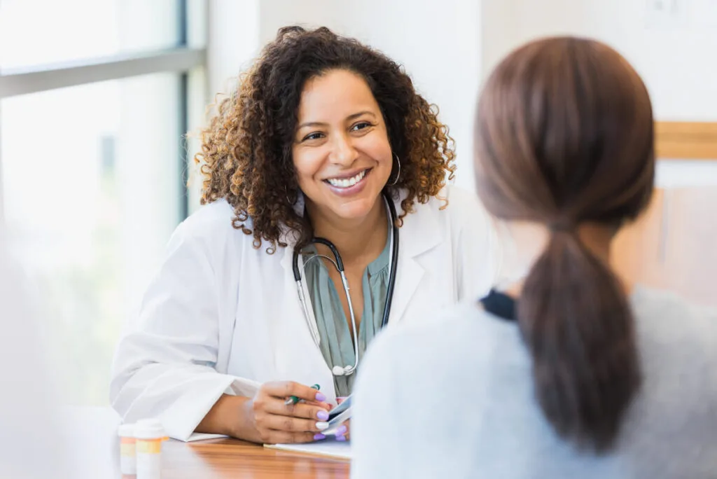 Caring doctor listens to patient for varicose veins treatment
